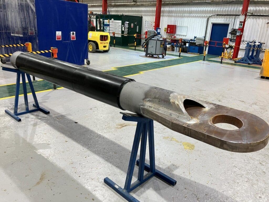 Forged subsea buckle arrestor with black anti-corrosion coating and raw end prep at LJF Custom Coatings facility