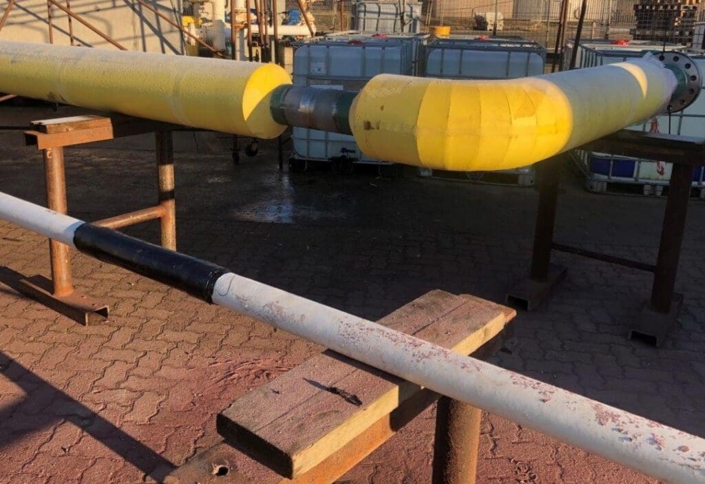 Yellow thermal insulation and black anti-corrosion coatings applied to subsea pipework at LJF Custom Coatings facility